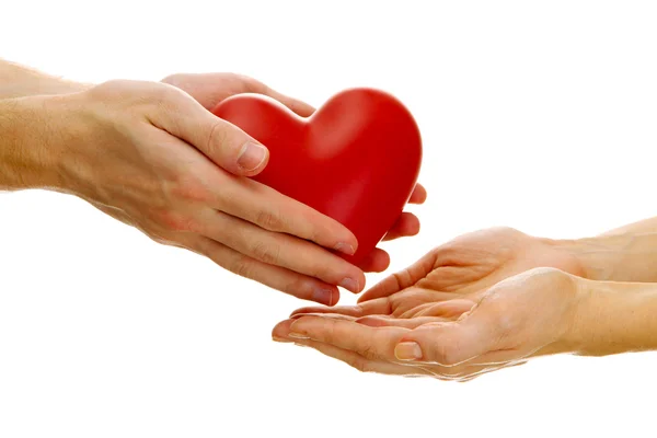 Red heart in woman and man hands, isolated on white — Stock Photo, Image