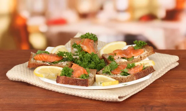 Salmon sandwich on plate,on bright background — Stock Photo, Image