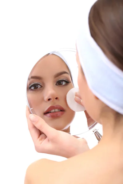 Young woman cleansing her face, isolated on white — Stock Photo, Image