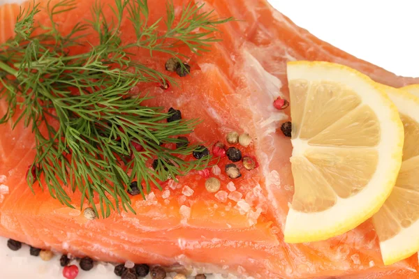 Fresh salmon fillet with herbals and lemon slices on plate,on wooden background Stock Picture