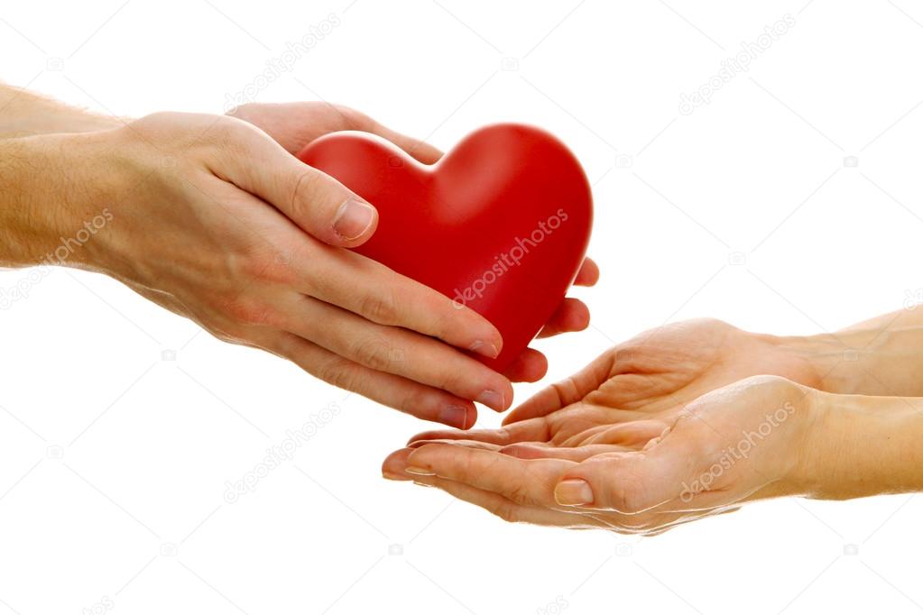 Red heart in woman and man hands, isolated on white