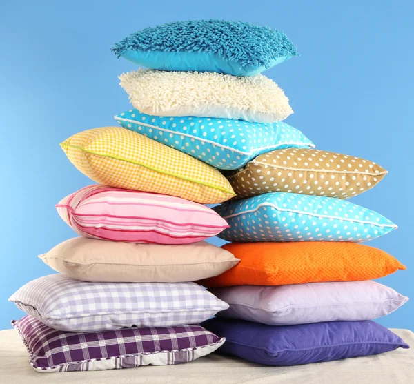 Hill colorful pillows on blue background — Stock Photo, Image