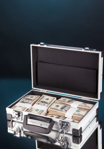 Suitcase with 100 dollar bills on dark color background — Stock Photo, Image