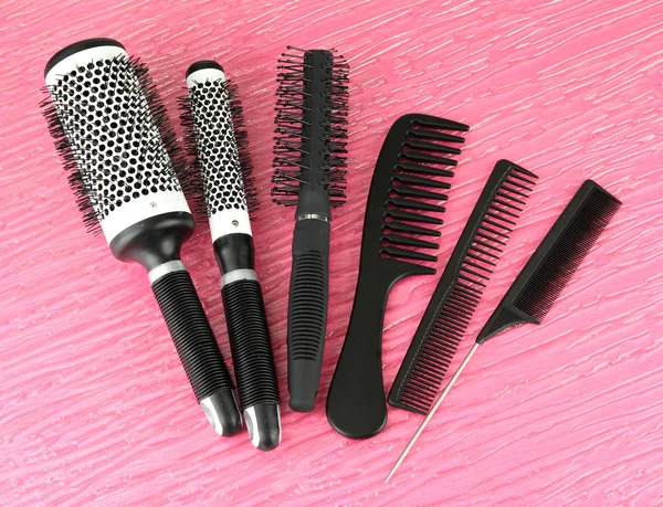 Black combs on color background — Stock Photo, Image