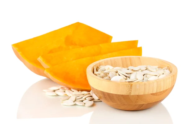 Pumpkin seeds in wooden bowl isolated on the white — Stock Photo, Image