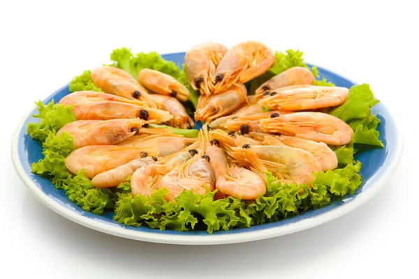 Boiled shrimps with lettuce leaves on plate, isolated on white — Stock Photo, Image