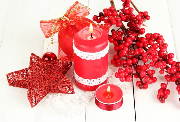 Red candle with christmas decoration on light background — Stock Photo, Image