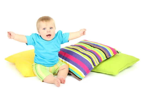 Menino e travesseiros de cor, isolados em branco — Fotografia de Stock