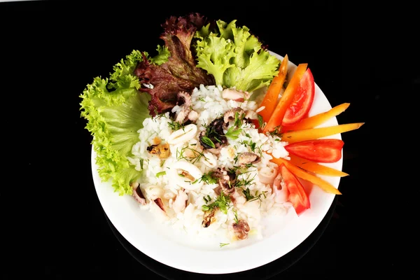 Delicatessen seafood salad with rice isolated on black — Stock Photo, Image