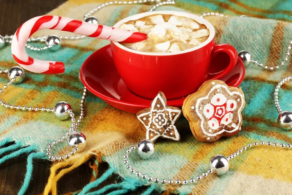 Cup of coffee with holiday candy on plaid close-up — Stock Photo, Image