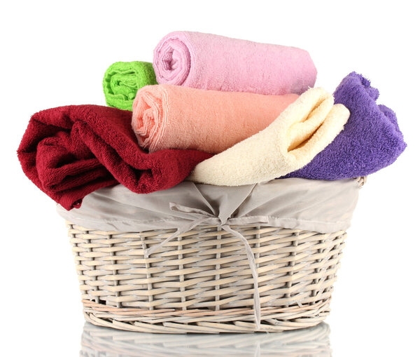 Colorful towels in basket isolated on white