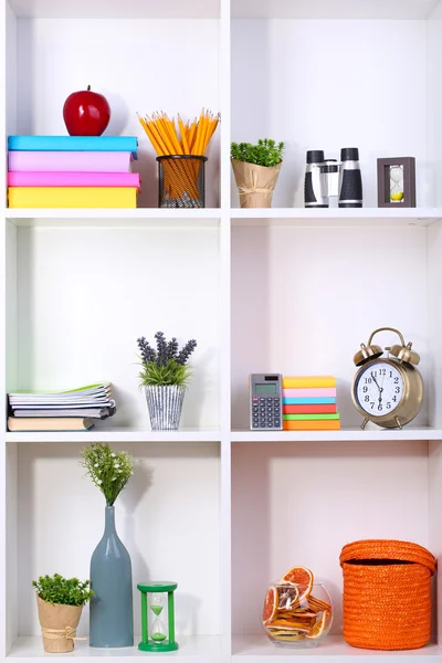 Beautiful white shelves with different home related objects — Stock Photo, Image