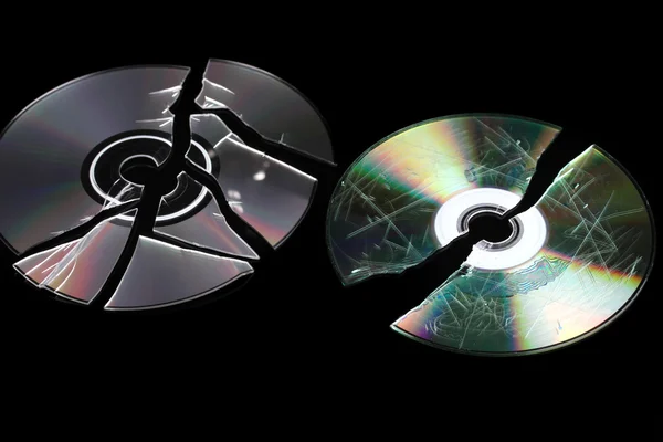 Defective and broken disks with information isolated on black — Stock Photo, Image