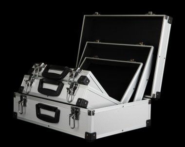 Opened silvery suitcases on black background