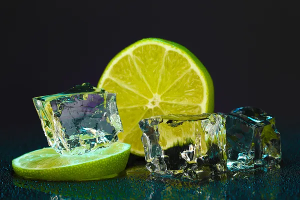 Ice cubes with lime on darck background — Stock Photo, Image