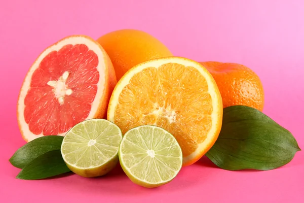 Fruits with leafs on pink background — Stock Photo, Image