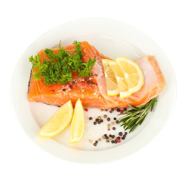 Fresh salmon fillet with herbals and lemon slices on plate, isolated on white — Stock Photo, Image