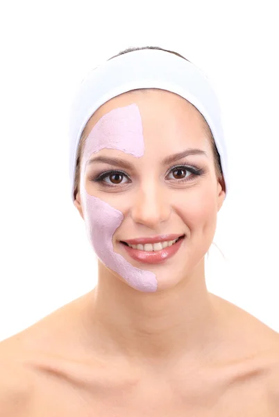 Jonge vrouw met klei gezichtsmasker, geïsoleerd op wit — Stockfoto