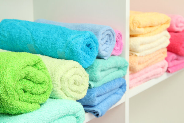 colorful towels on shelves in bathroom