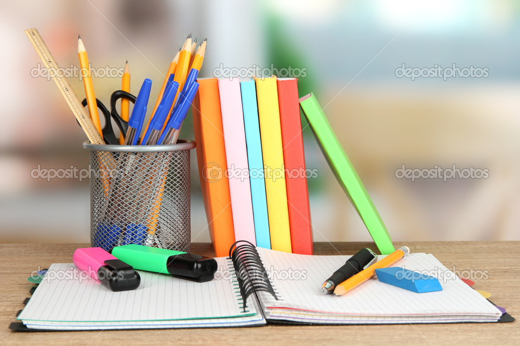 School supplies and books on wooden table