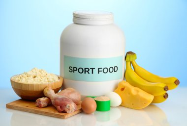 jar of protein powder and food with protein, on blue background clipart