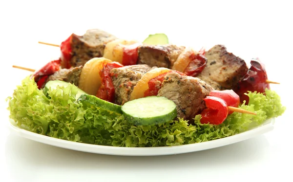 Tasty grilled meat and vegetables on skewers on plate, isoalted on white — Stock Photo, Image