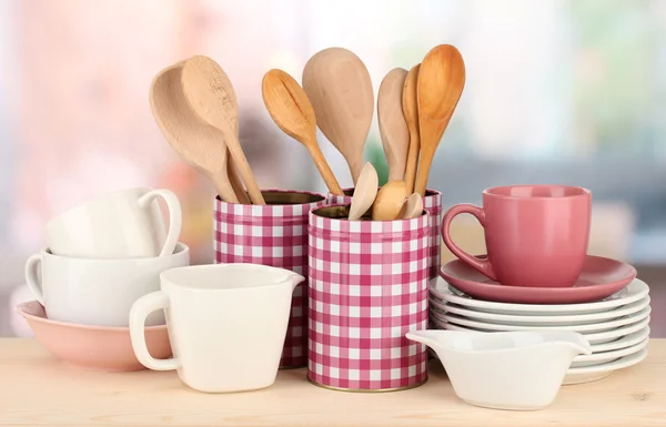 Cups, bowls nd other utensils in metal containers isolated on light background — Stock Photo, Image