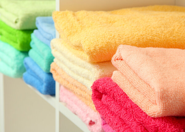 colorful towels on shelves in bathroom