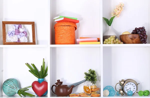 Beautiful white shelves with scattered different home related objects — Stock Photo, Image