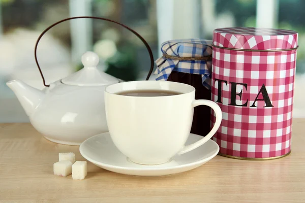 Jar and cup of tea isolated on white — Stock Photo, Image