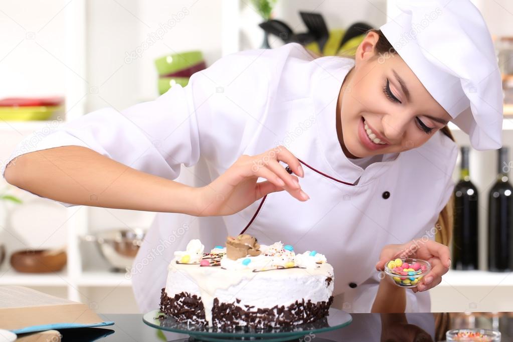 Joven cocinera cocinando pastel en la cocina — Foto de ...