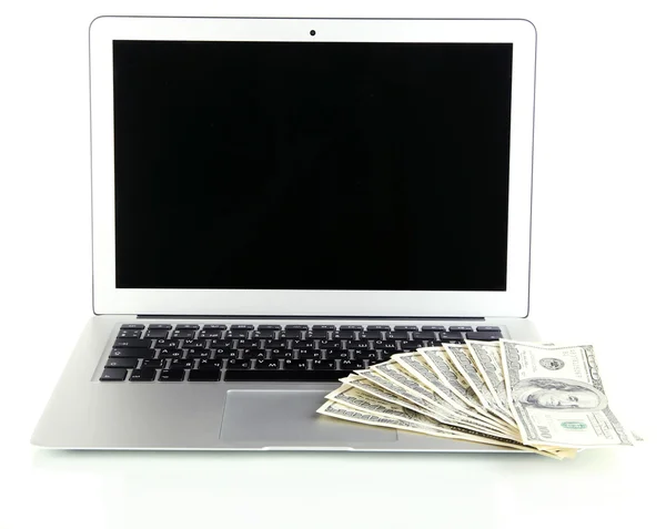 Geld op laptop geïsoleerd op wit — Stockfoto