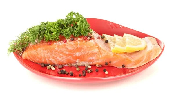 Fresh salmon fillet with herbals and lemon slices on plate, isolated on white — Stock Photo, Image