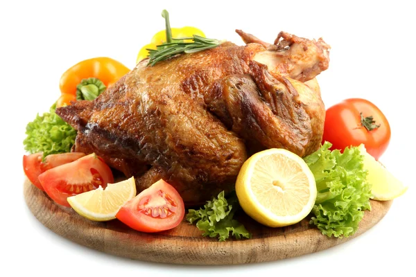 Whole roasted chicken on wooden plate with vegetables, isolated on white — Stock Photo, Image