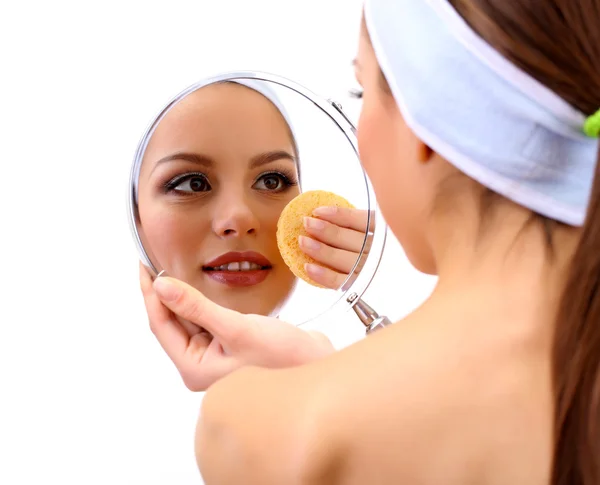 Young woman cleansing her face, isolated on white — Stock Photo, Image