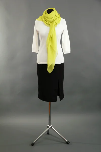 White blouse, black skirt and green scarf on mannequin on grey background — Stock Photo, Image