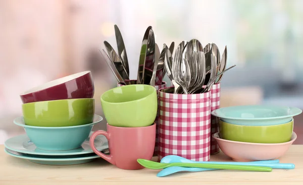 Cups, bowls nd other utensils in metal containers isolated on light background — Stok fotoğraf