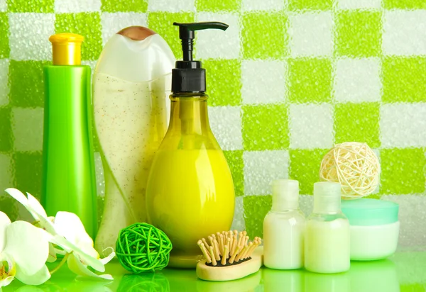 Bath accessories on shelf in bathroom on green tile wall background — Stock Photo, Image