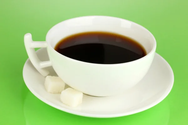 A cup of strong coffee on green background — Stock Photo, Image