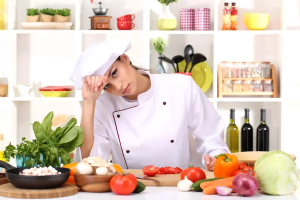 Young woman chef cooking in kitchen — Stock Photo, Image