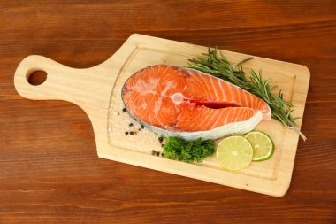 ahşap zemin üzerinde kesme tahtası üzerinde taze somon steak