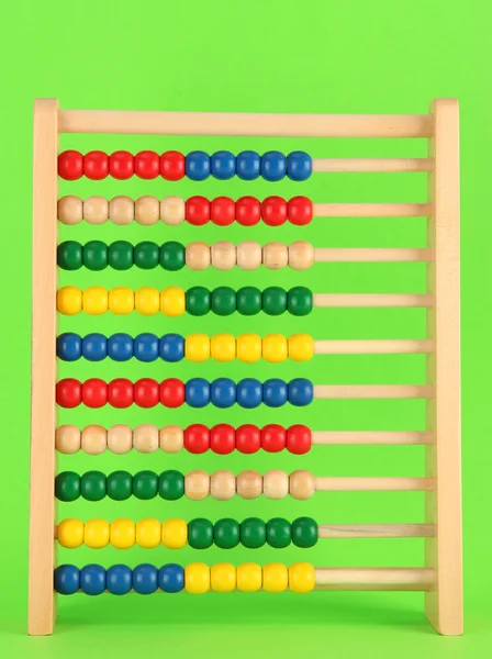 Lichte houten speelgoed abacus, op groene achtergrond — Stockfoto