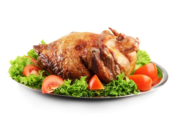 Tasty whole roasted chicken on plate with vegetables, isolated on white Stock Image