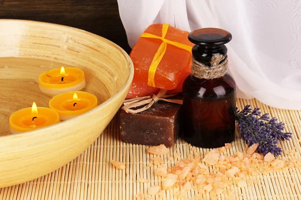 Bottle with aromatic oils with accessories for relaxation on wooden table on wooden background — Stock Photo, Image