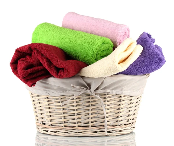 Colorful towels in basket isolated on white — Stock Photo, Image