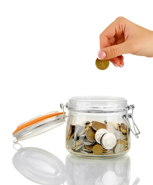 Saving, female hand putting a coin into glass bottle, isolated on white — Stock Photo, Image