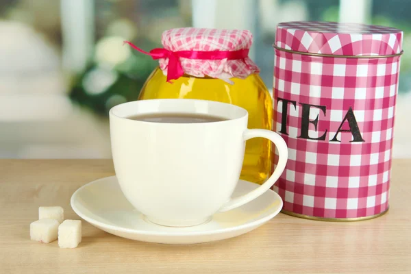 Jar and cup of tea isolated on white — Stock Photo, Image