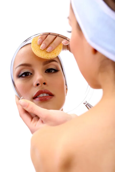 Young woman cleansing her face, isolated on white — Stock Photo, Image