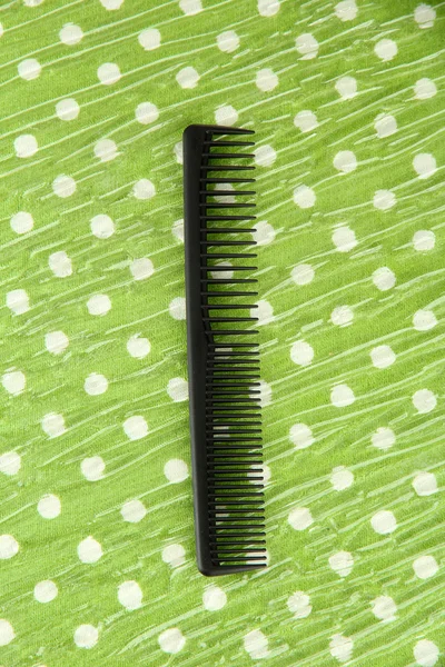 Black comb on color background — Stock Photo, Image