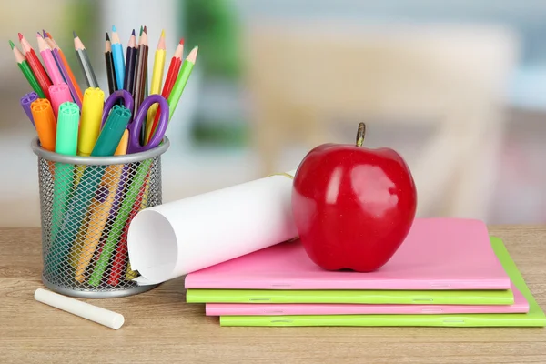 School supplies with red apple on wooden table — Stock Photo, Image